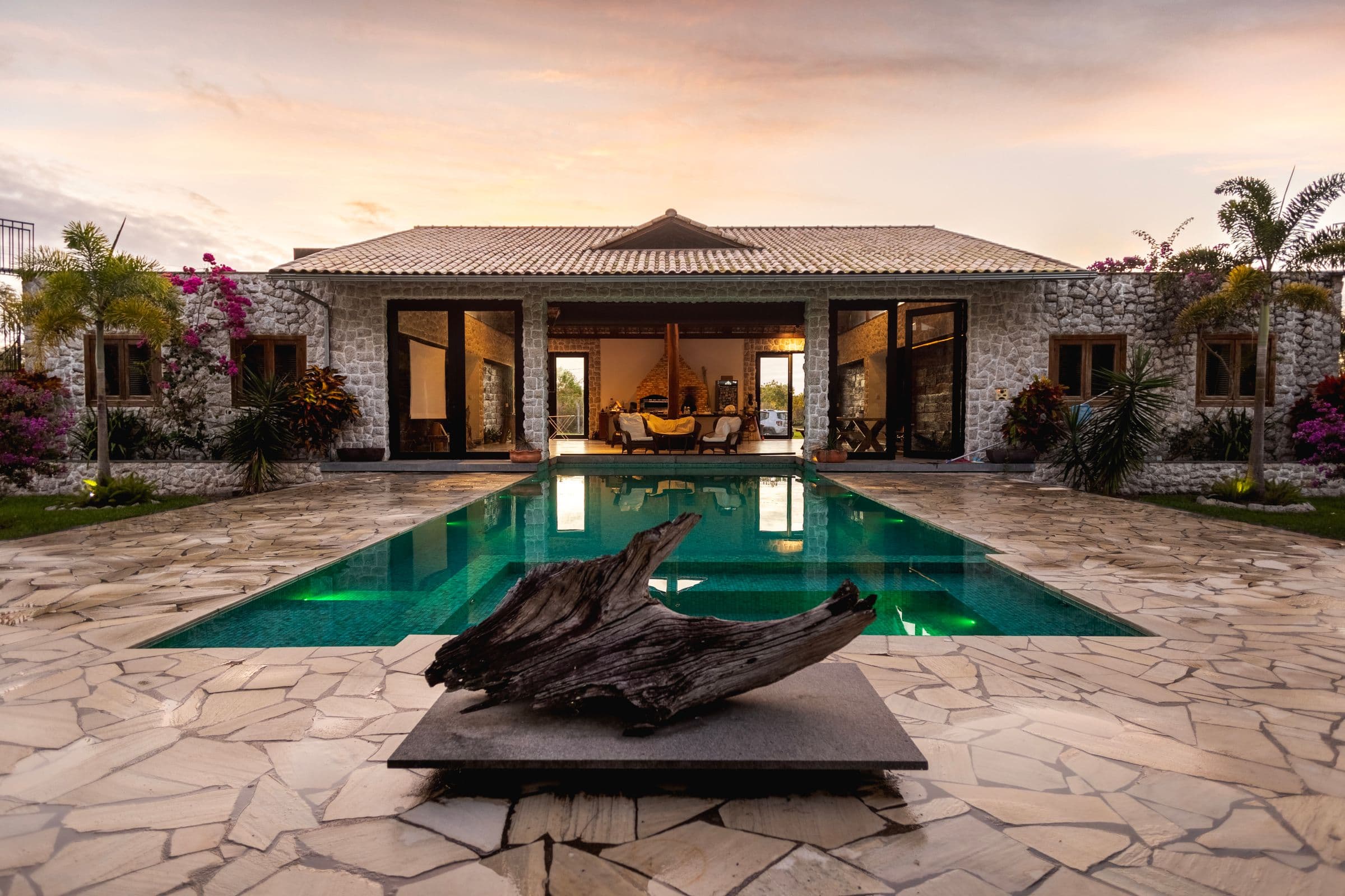 Luxury villa estate with tropical gardens and infinity pool at sunset